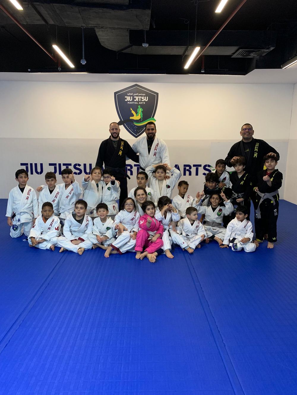 Kids Brazilian Jiu Jitsu Qatar — a large class with their coaches at JJMA Doha