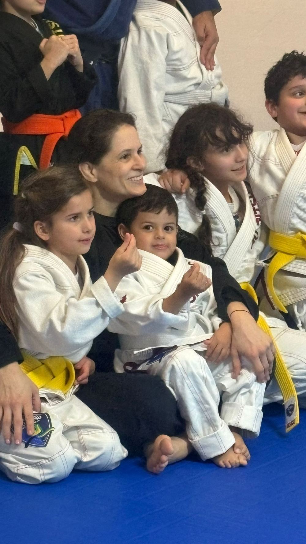 Kids jiu jitsu Qatar — young students smiling during a class at JJMA Doha